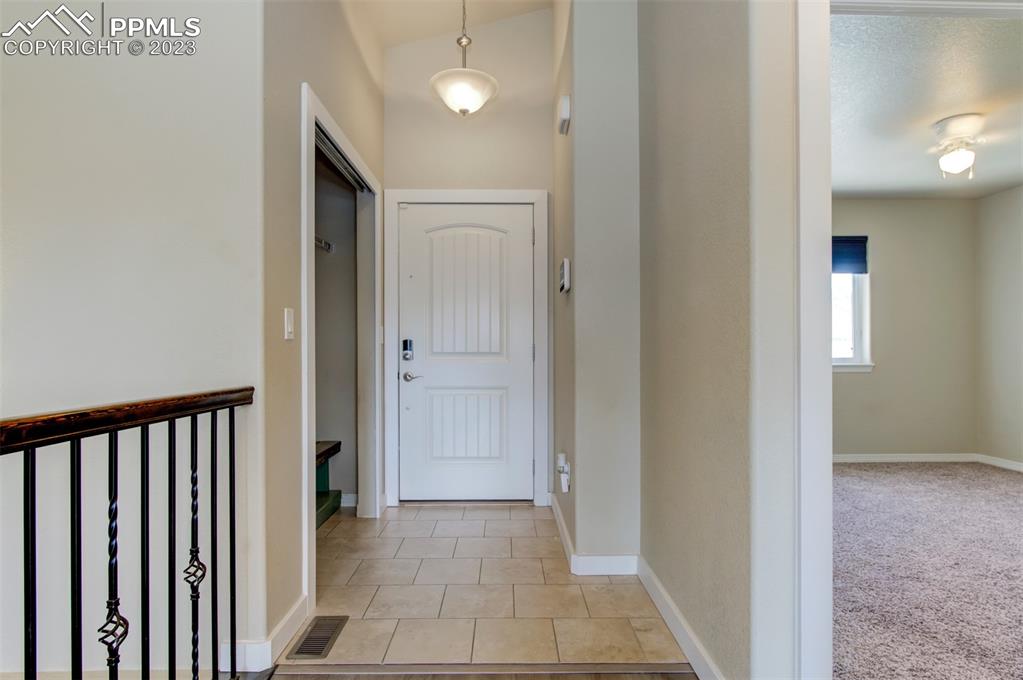 10034 Intrepid Way Colorado Springs, CO 80925 - Photo 3 of 31 a view of a hallway with a door
