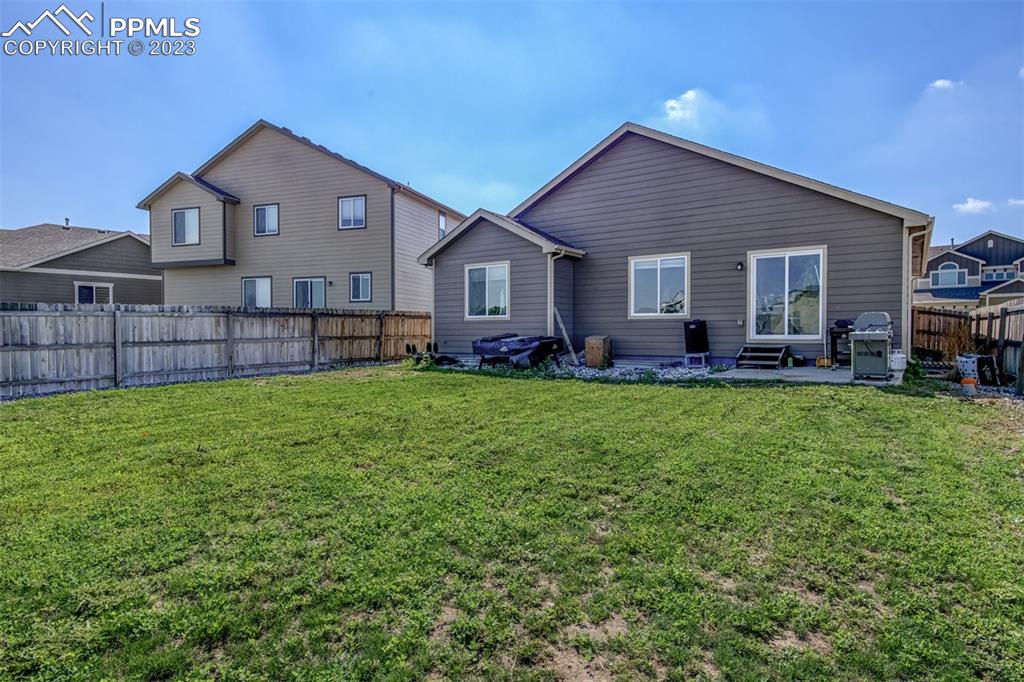 10034 Intrepid Way Colorado Springs, CO 80925 - Photo 31 of 31 a front view of house with yard and green space