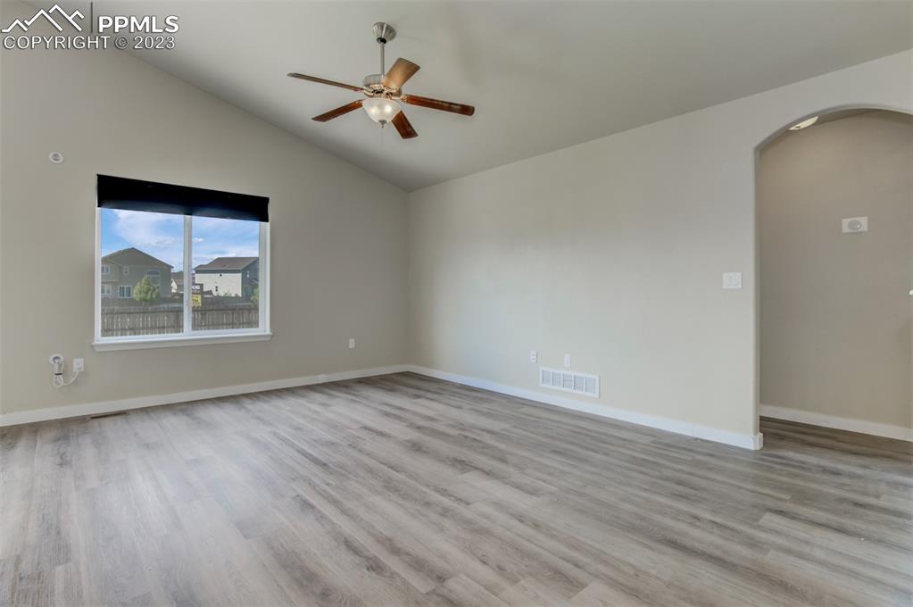 10034 Intrepid Way Colorado Springs, CO 80925 - Photo 4 of 31 an empty room with wooden floor and windows