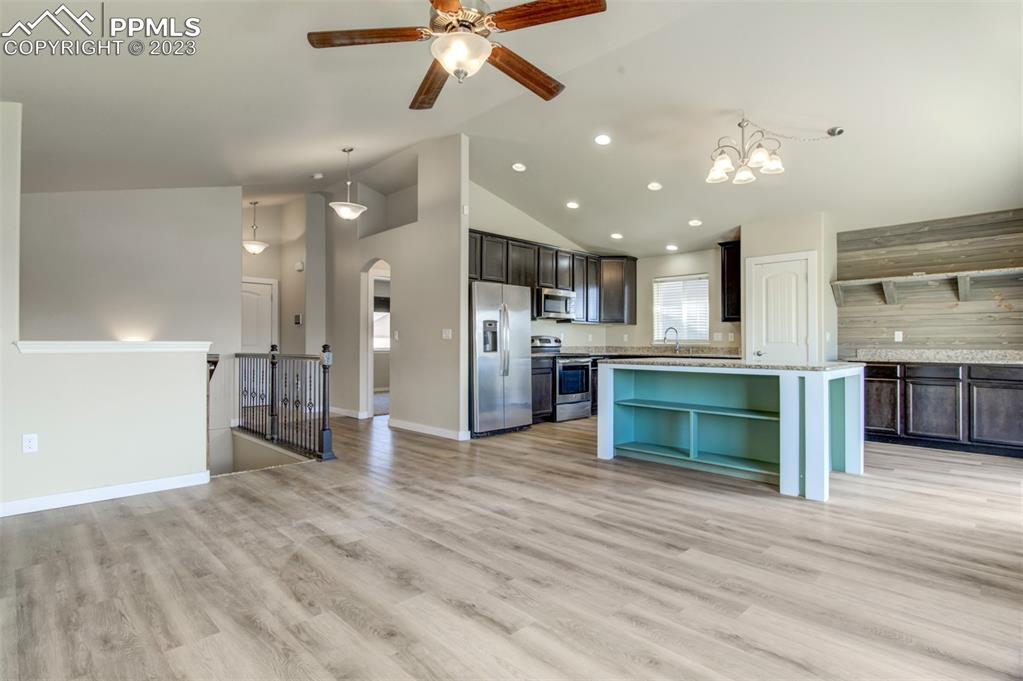 10034 Intrepid Way Colorado Springs, CO 80925 - Photo 6 of 31 a view of a kitchen with a sink and a fireplace