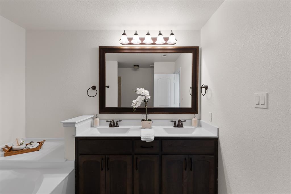 186 County Road 4430 Rhome, TX 76078 - Photo 21 of 40 a bathroom with a sink and a mirror