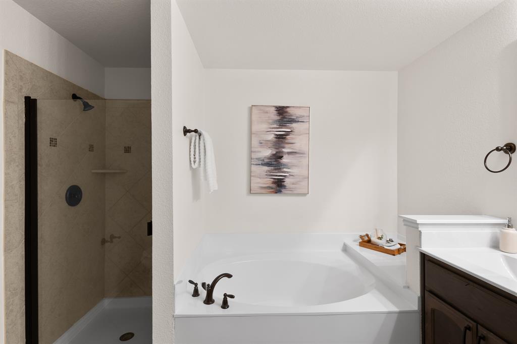 186 County Road 4430 Rhome, TX 76078 - Photo 22 of 40 a bathroom with a bathtub and a shower