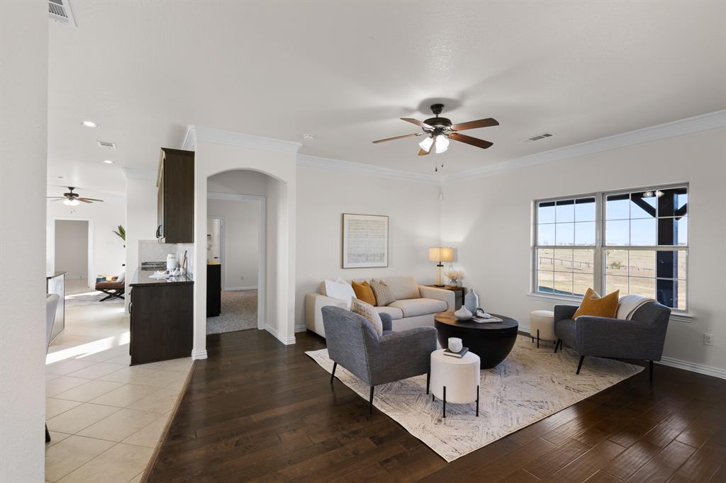 186 County Road 4430 Rhome, TX 76078 - Photo 7 of 40 a living room with furniture two large window and a table