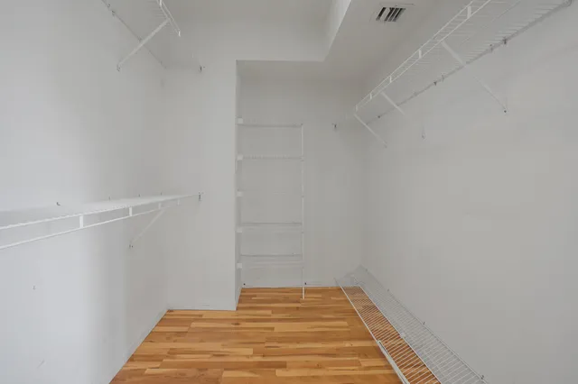 an empty room with a ceiling fan and window