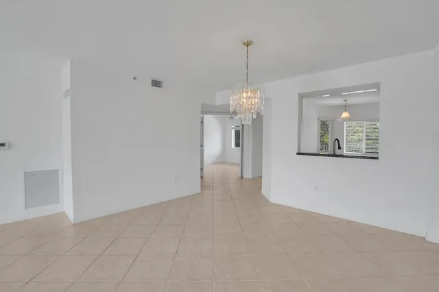 a view of a hallway with a chandelier