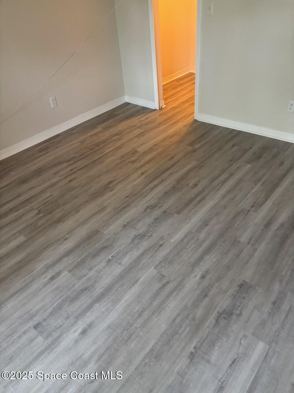 7667 North Wickham Road, Unit 720 Melbourne, FL 32940 - Photo 17 of 28 a view of an empty room with wooden floor