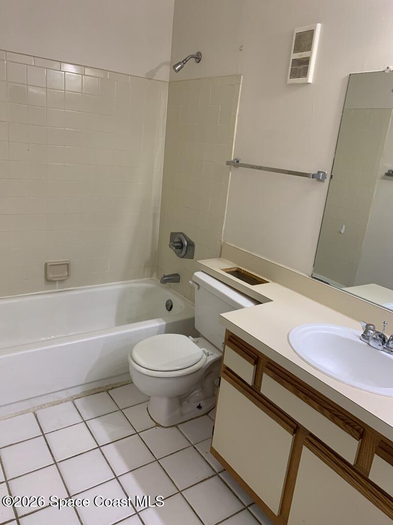 7667 North Wickham Road, Unit 720 Melbourne, FL 32940 - Photo 19 of 28 a bathroom with a sink a toilet and shower