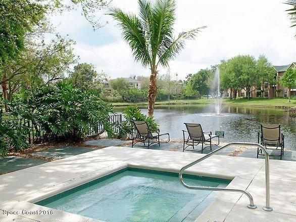 7667 North Wickham Road, Unit 720 Melbourne, FL 32940 - Photo 25 of 28 a view of a lake with a patio