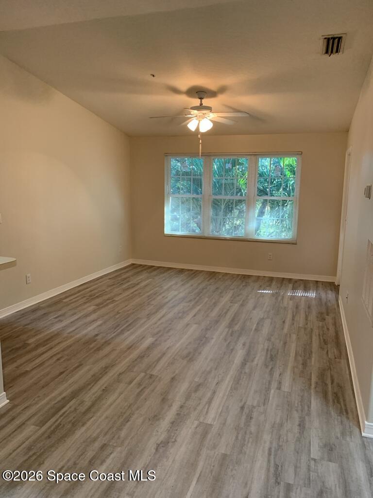 7667 North Wickham Road, Unit 720 Melbourne, FL 32940 - Photo 7 of 28 wooden floor in an empty room with a window
