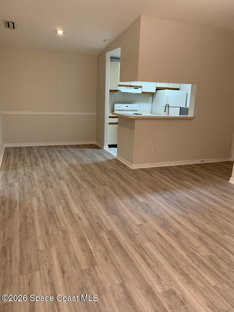 7667 North Wickham Road, Unit 720 Melbourne, FL 32940 - Photo 8 of 28 a view of a kitchen with wooden floor and a sink