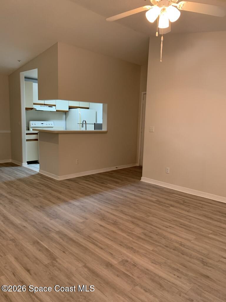 7667 North Wickham Road, Unit 720 Melbourne, FL 32940 - Photo 9 of 28 a view of kitchen cabinets and wooden floor