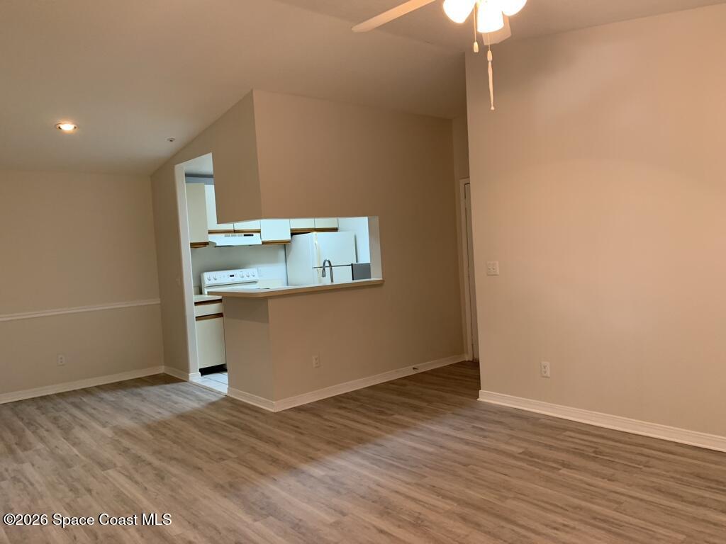 7667 North Wickham Road, Unit 720 Melbourne, FL 32940 - Photo 10 of 28 an empty room with wooden floor and door