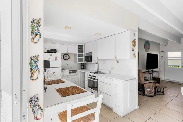 a kitchen with a refrigerator and a sink