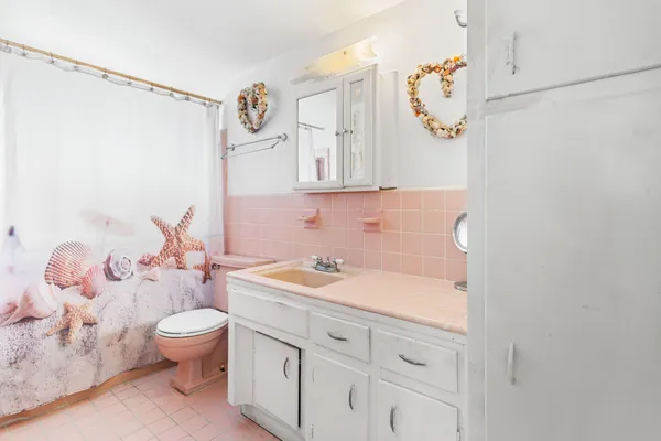 a bathroom with a sink a toilet and a mirror