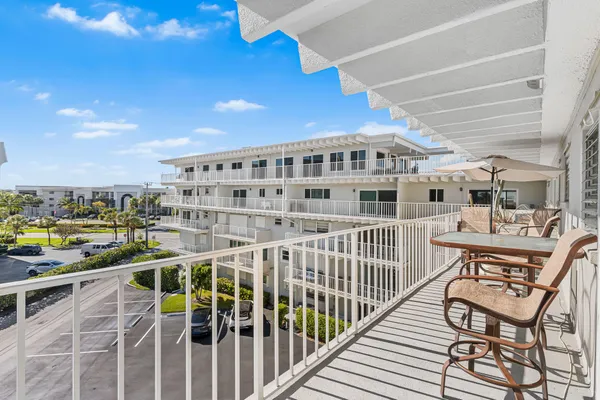 a view of a balcony with chairs