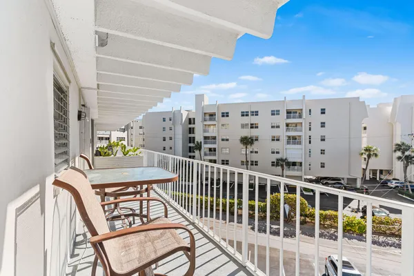 a view of a balcony with furniture
