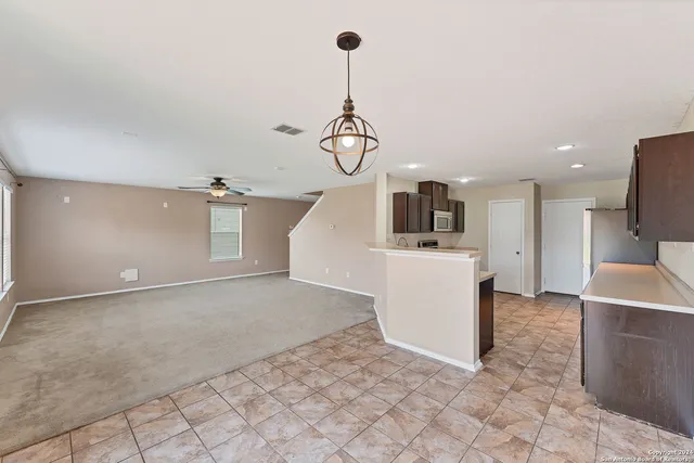 a view of a kitchen with microwave and cabinets