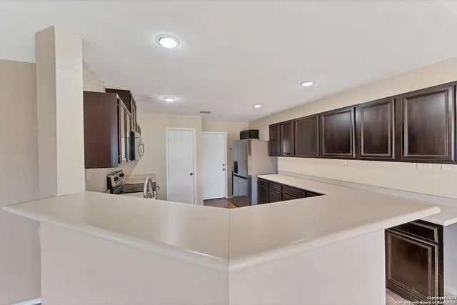 a kitchen with stainless steel appliances granite countertop a sink and a microwave