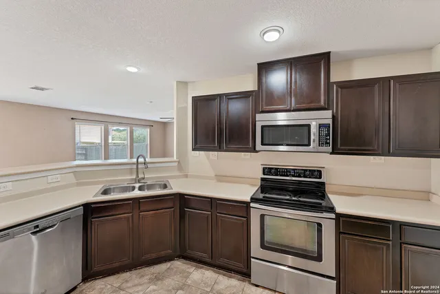 a kitchen with a sink stove and microwave