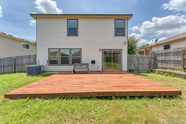 a backyard of a house with table and chairs