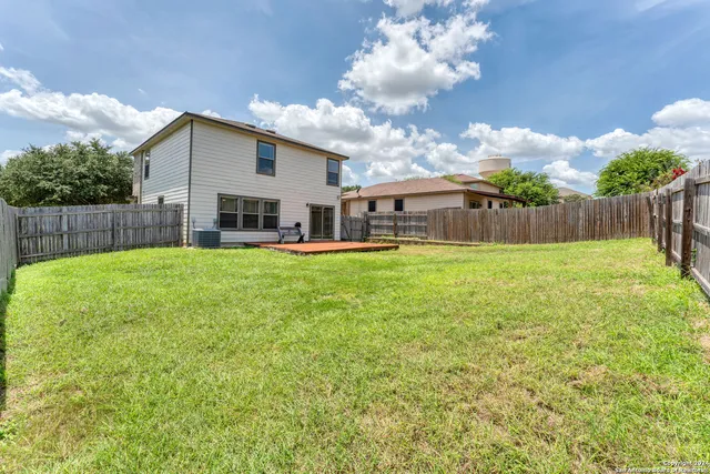 a view of a house with a yard and sitting area