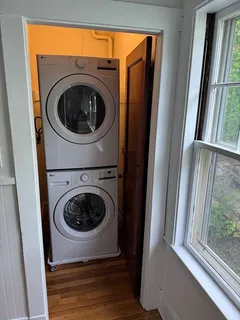 a utility room with washing machine and a window