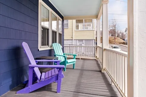 a view of a chair and tables in the balcony