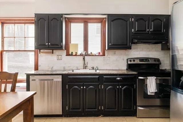 a kitchen with stainless steel appliances granite countertop a stove and a sink