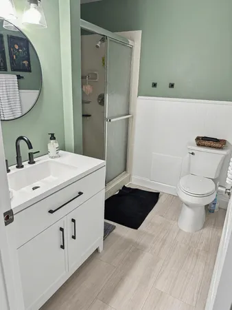 a bathroom with a sink toilet and shower