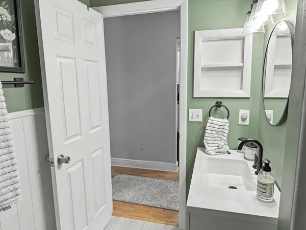 a bathroom with a sink a toilet and mirror