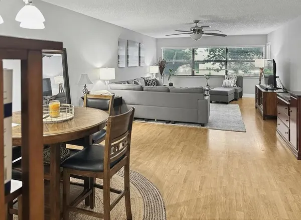 a kitchen with a table chairs stove and cabinets