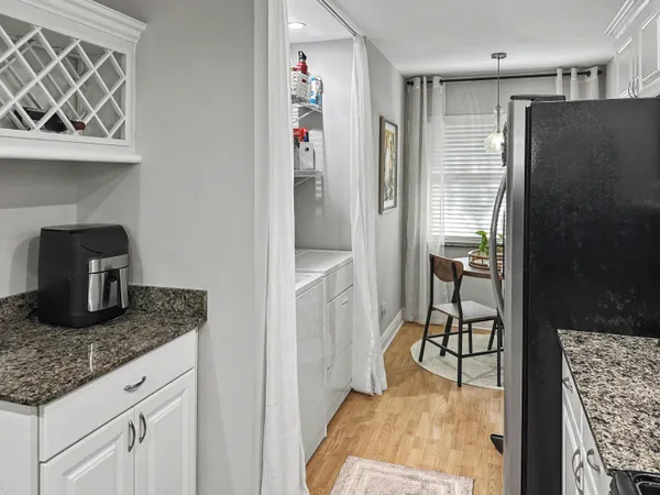 a kitchen with stainless steel appliances granite countertop a refrigerator and a sink