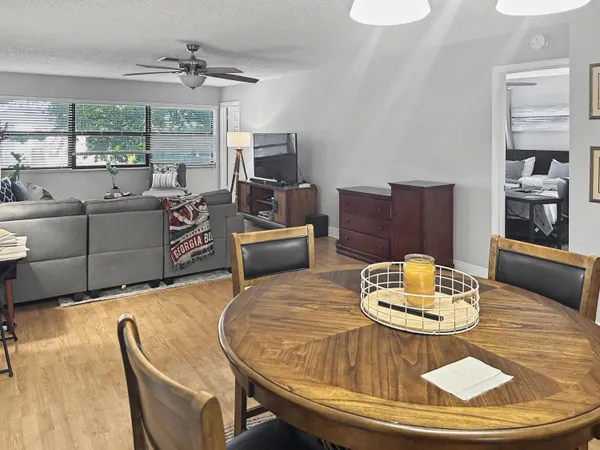 a living room with furniture and a kitchen view