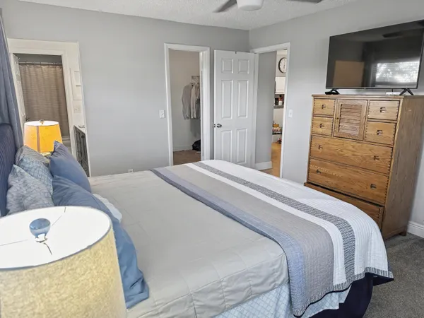 a bedroom with a bed and flat screen tv