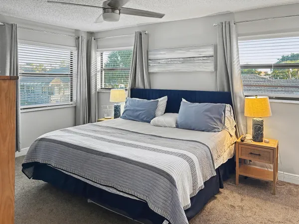 a bedroom with a bed a window and lamps