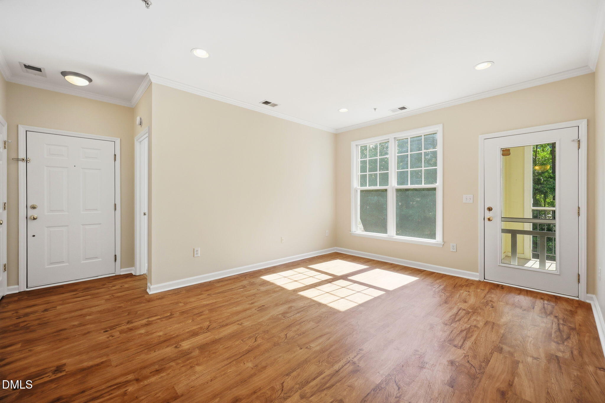 801 Moratuck Drive, Unit 202 Raleigh, NC 27604 - Photo 9 of 23 an empty room with wooden floor and windows