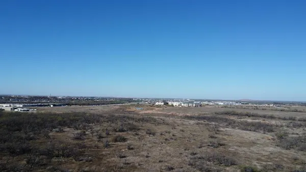 a view of ocean with large trees