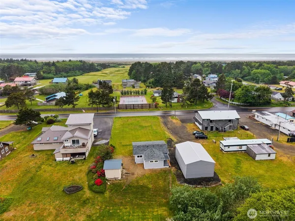 an aerial view of a house with swimming pool lake view and mountain view