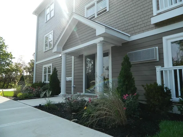 a view of a house with garden and pathway