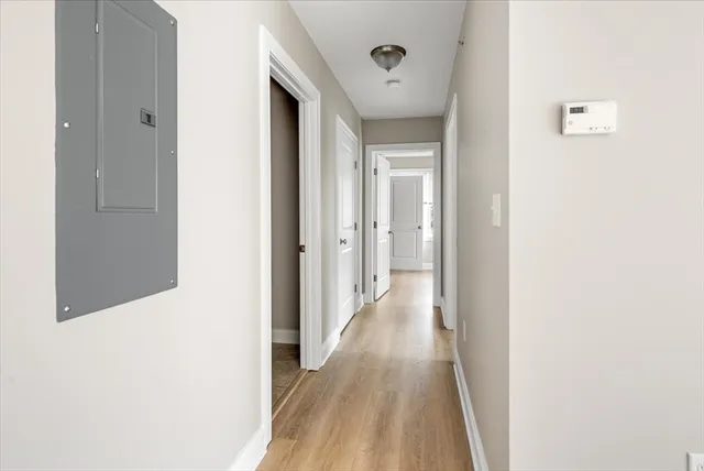 a view of a hallway with wooden floor