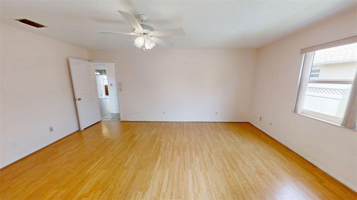 137 Concha Drive Sebastian, FL 32958 - Photo 12 of 21 a view of a room with wooden floor and ceiling fan