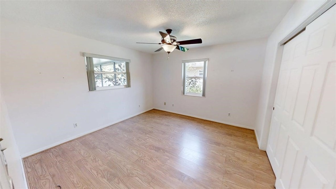 137 Concha Drive Sebastian, FL 32958 - Photo 13 of 21 an empty room with wooden floor ceiling fan and window
