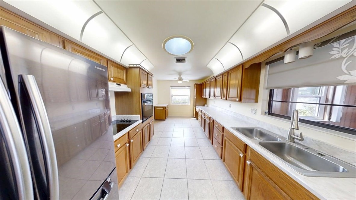 137 Concha Drive Sebastian, FL 32958 - Photo 2 of 21 a large kitchen with stainless steel appliances granite countertop a sink and cabinets