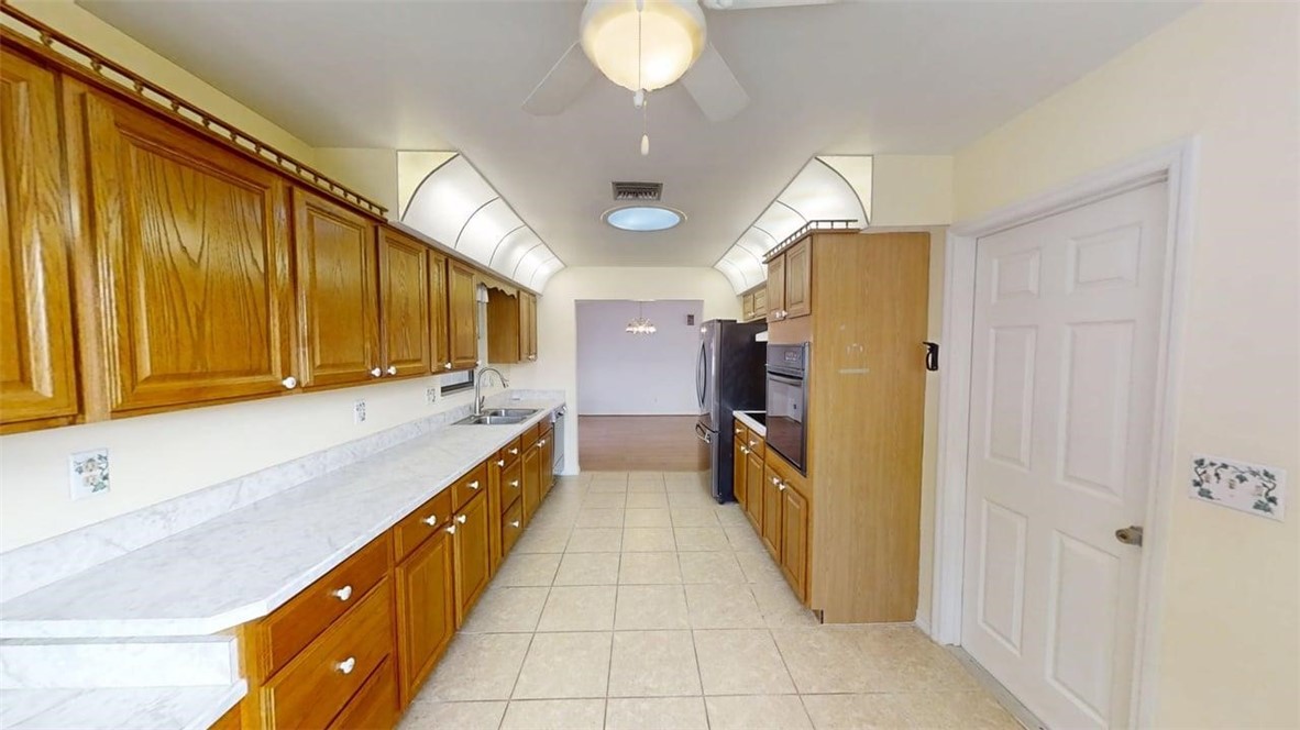 137 Concha Drive Sebastian, FL 32958 - Photo 3 of 21 a large kitchen with a sink and dishwasher a refrigerator with wooden floor