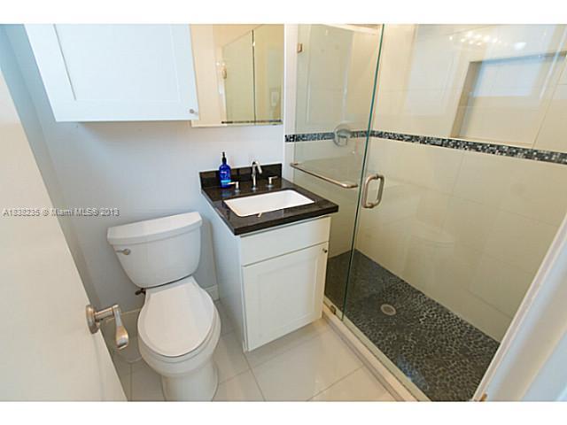 5767 Southwest 35th Street Miami, FL 33155 - Photo 11 of 18 a bathroom with a toilet a sink and a shower