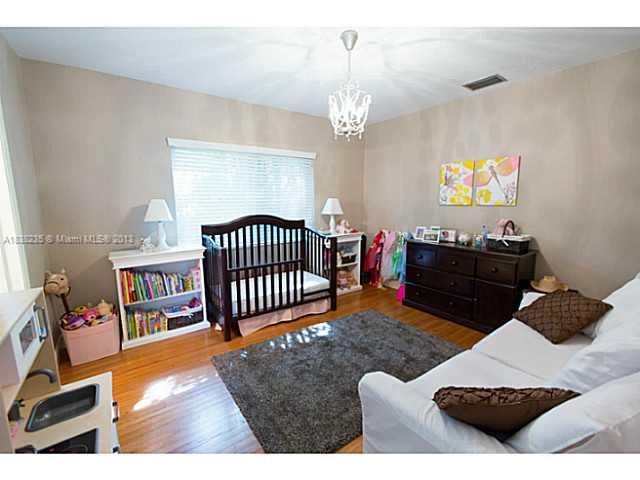 5767 Southwest 35th Street Miami, FL 33155 - Photo 12 of 18 a living room with furniture and a chandelier