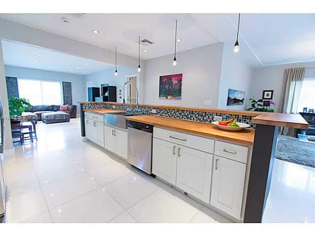 5767 Southwest 35th Street Miami, FL 33155 - Photo 5 of 18 a large kitchen with kitchen island a sink stainless steel appliances and cabinets