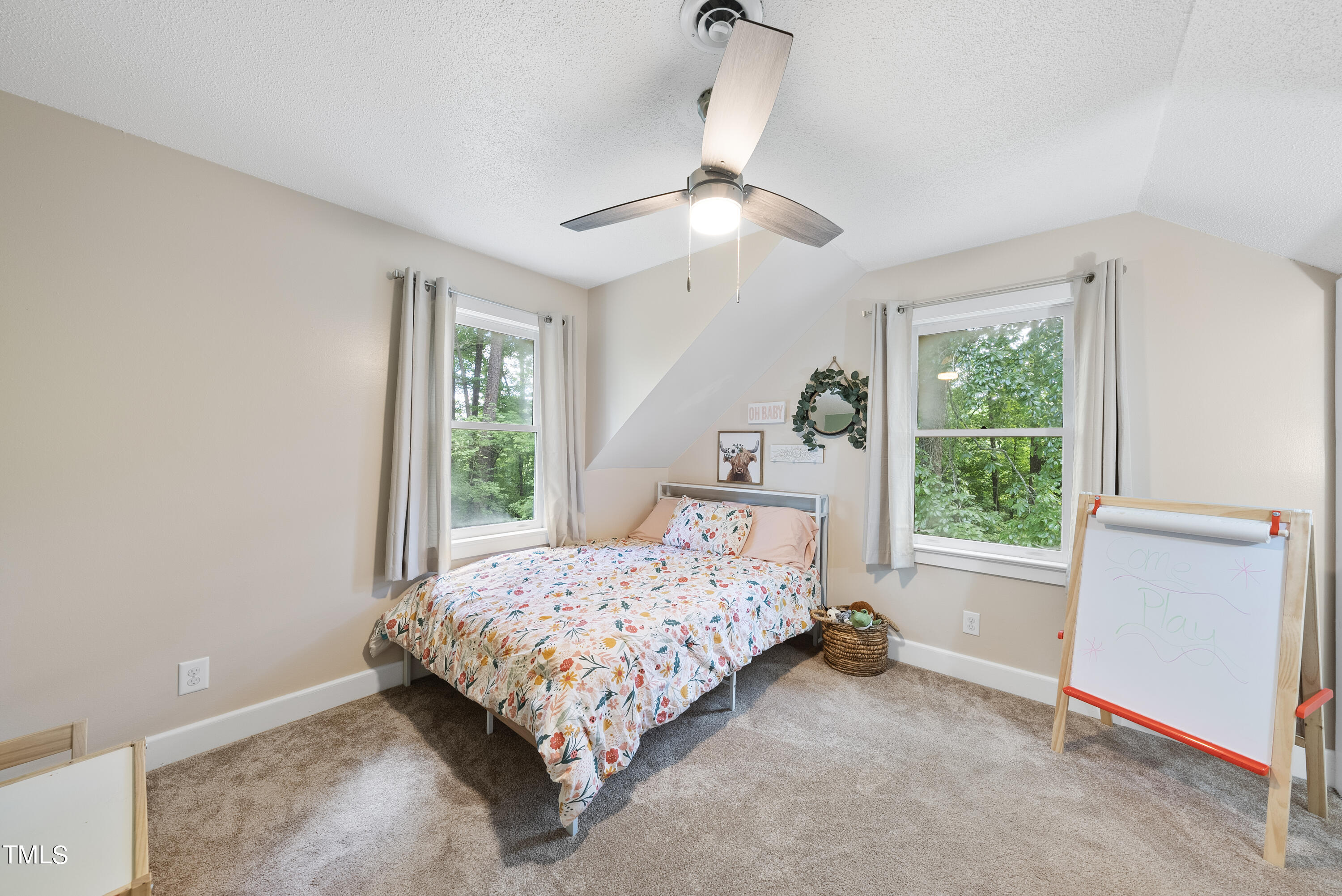 6319 Carbonton Road Sanford, NC 27330 - Photo 11 of 19 a bed sitting in a room next to a window