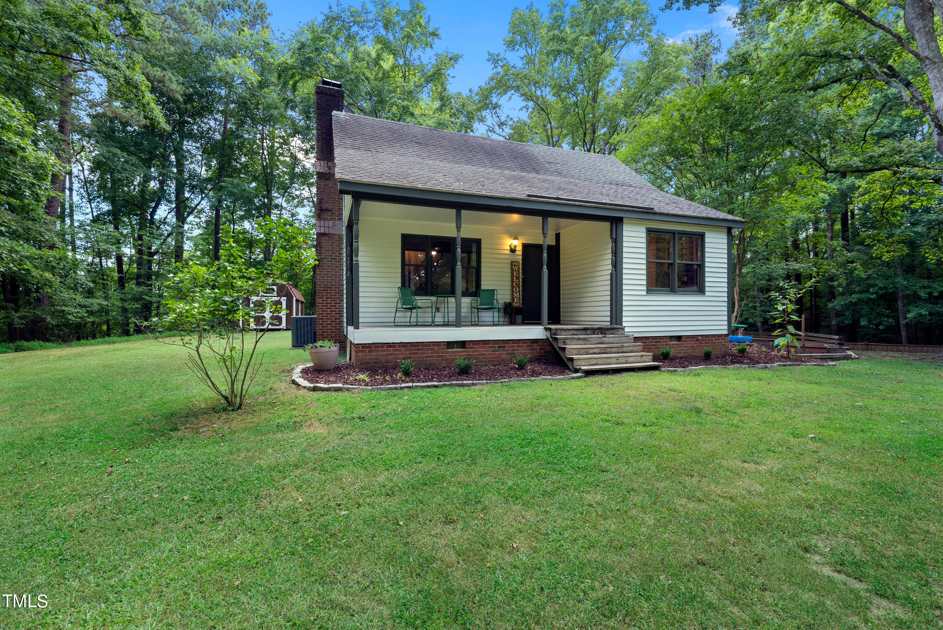 6319 Carbonton Road Sanford, NC 27330 - Photo 4 of 19 a house view with a garden space