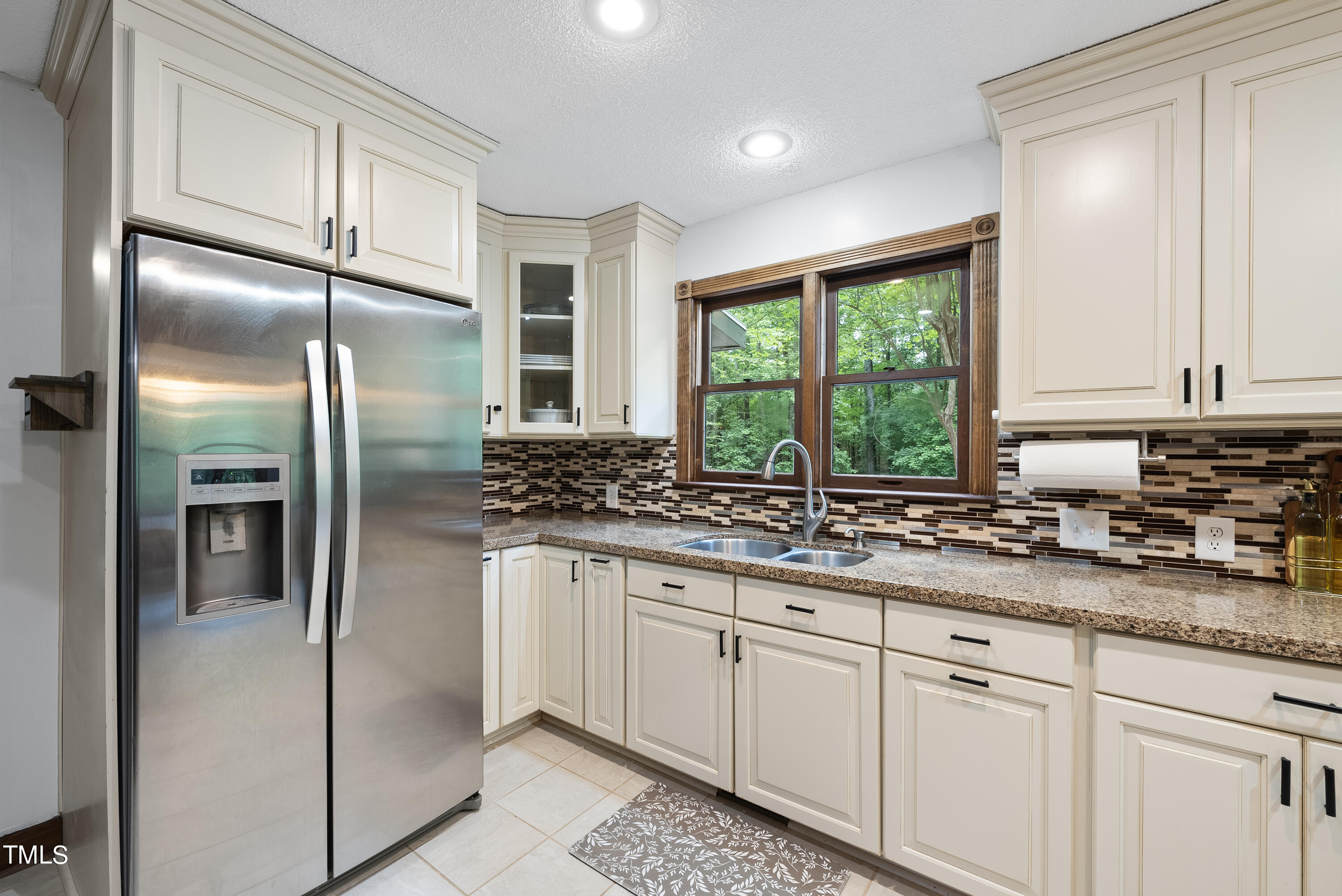 6319 Carbonton Road Sanford, NC 27330 - Photo 8 of 19 a kitchen with stainless steel appliances granite countertop a refrigerator a sink and white cabinets